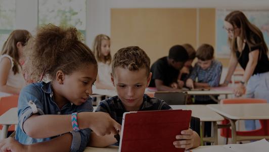 School teachers in group activities around tablets