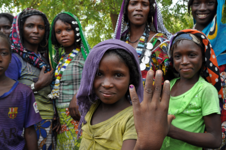 girl showing polio immunization mark 