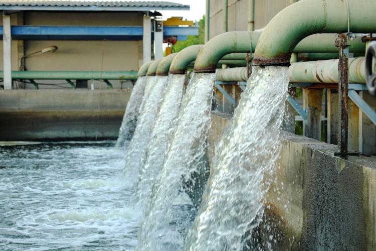 Water flows from a pipe for cooling of machine